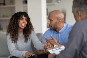 black couple in a therapy session with a male therapist